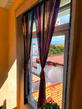 Mango Gifts sari bell accents curtain bottom adds playful detail.