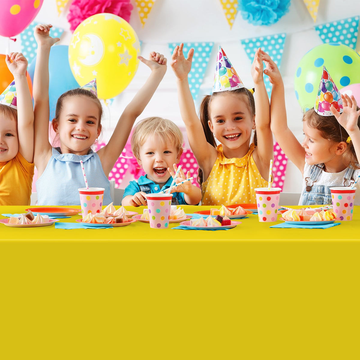 MASHAN colorful party setup with rainbow tablecloth enhancing decor.