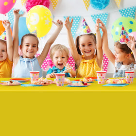 MASHAN colorful party setup with rainbow tablecloth enhancing decor.