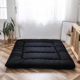 Dorm room scene with MAXYOYO mattress used as lounging and sleeping surface.