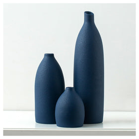 Mdaolv matte blue large vase shown as a bold coastal centerpiece with fresh stems.