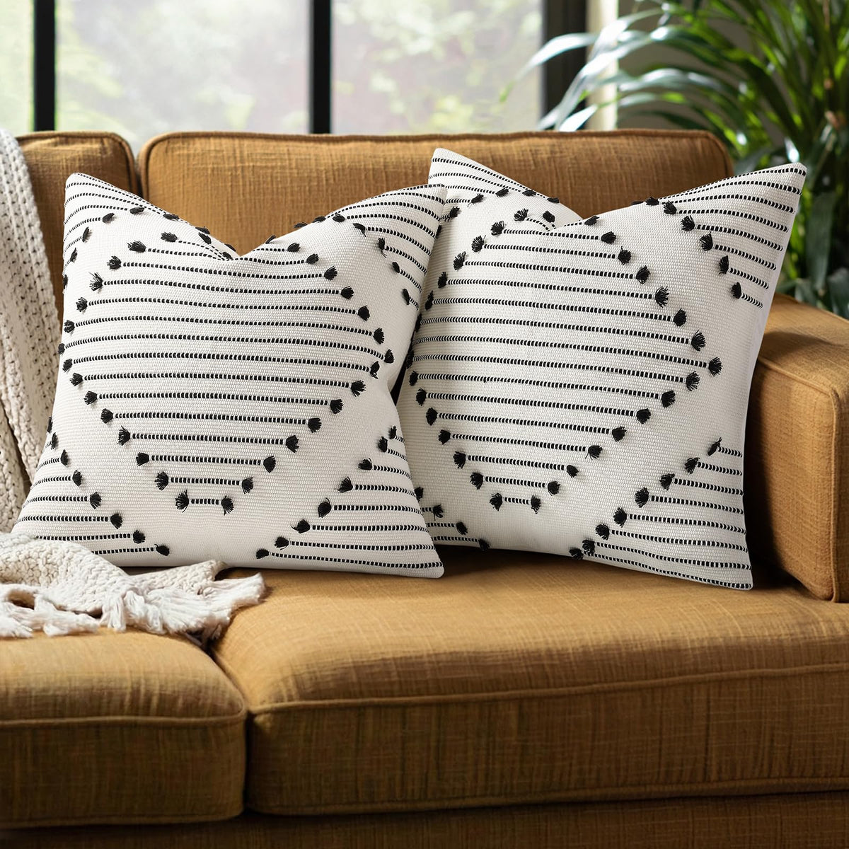 Mecatny boho-knit outdoor pillow cover with black tassels for patio decor.