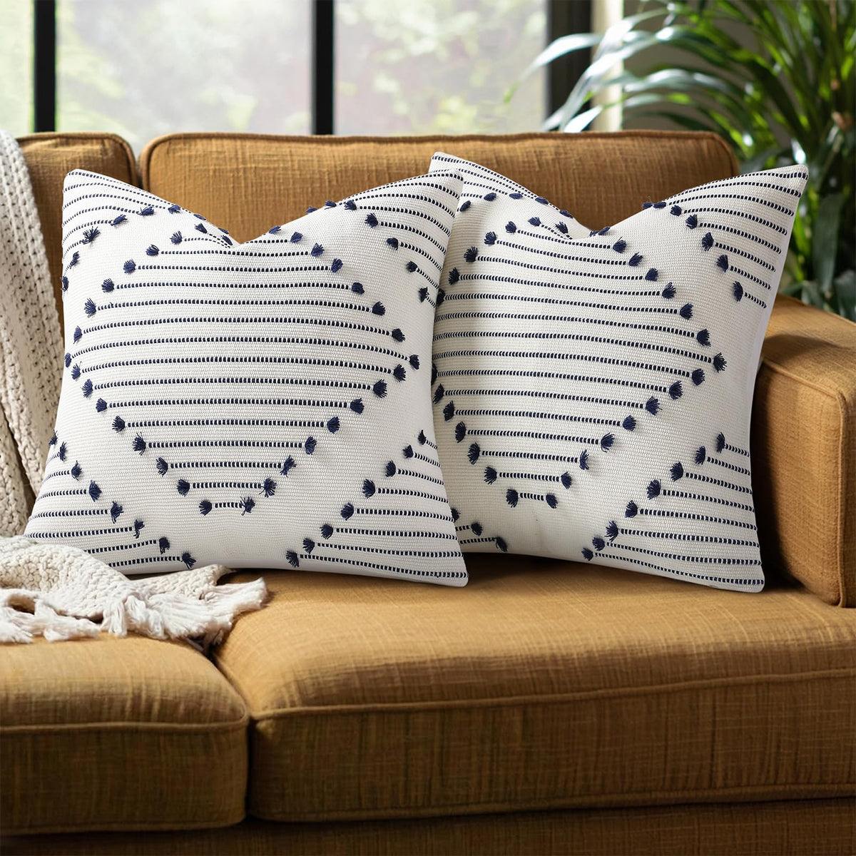 Mecatny Boho pillow cover in navy-cream tassels adds outdoor warmth.