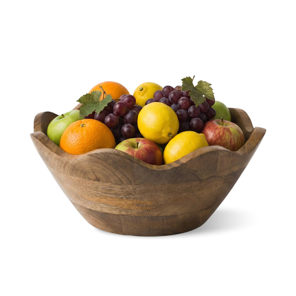 Mela Artisans scalloped mango wood bowl on countertop for decorative fruit display.