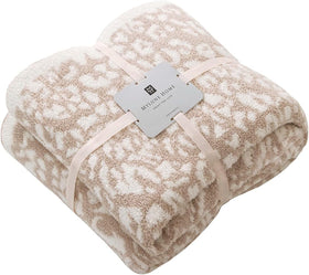 MH MYLUNE HOME ultra-soft leopard throw blanket on a sofa for cozy evenings.