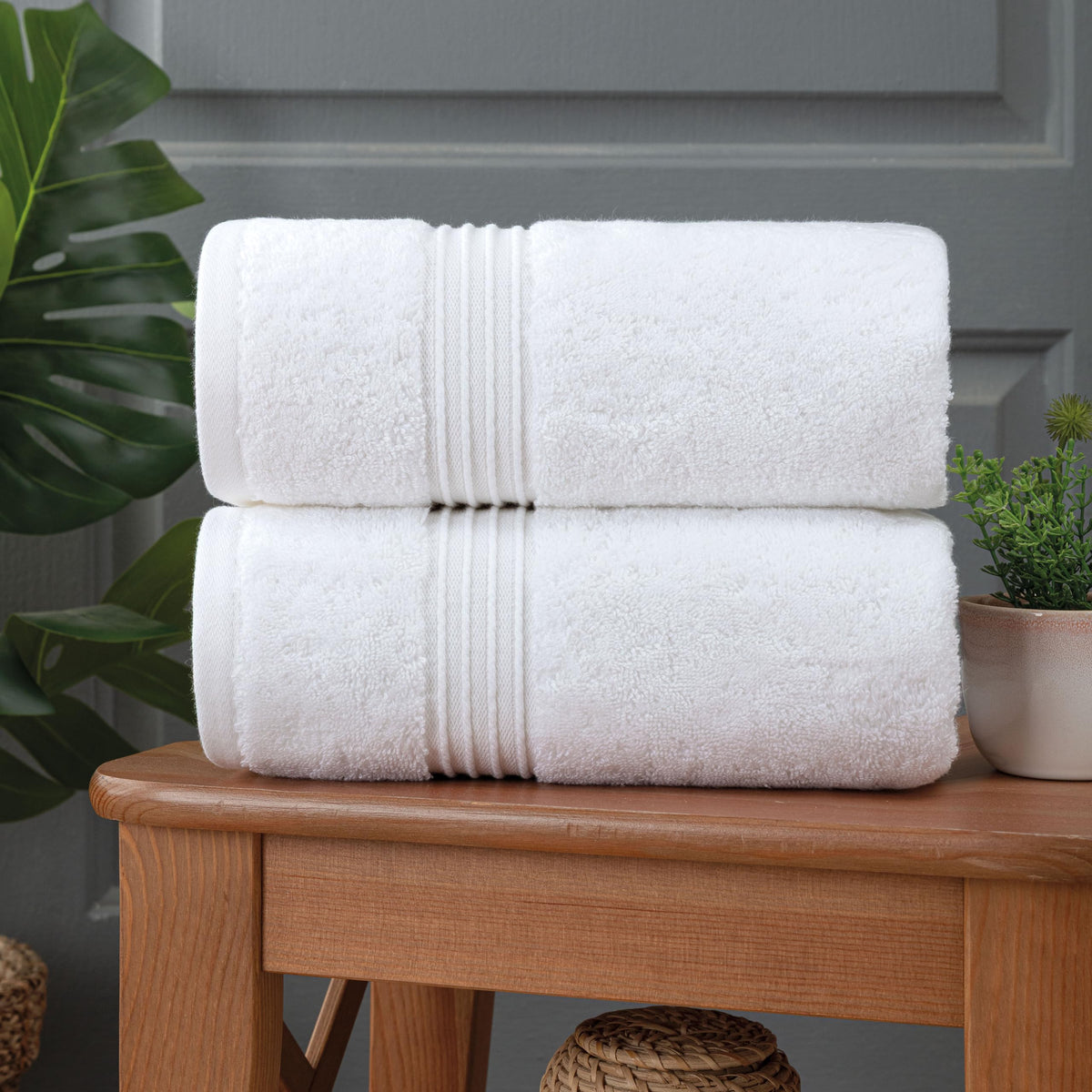 Milara white towels hanging in a bright modern bathroom.