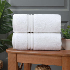 Milara white towels hanging in a bright modern bathroom.