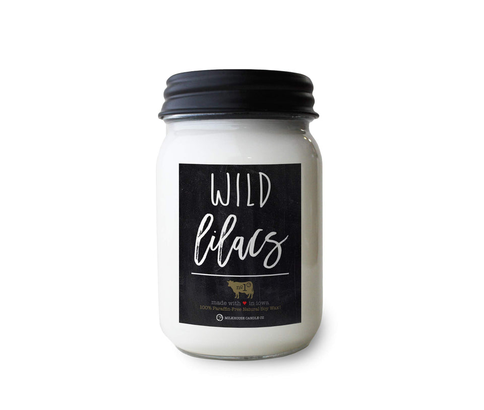 Milkhouse Wild Lilacs candle in a 13 oz jar with lid, inviting floral ambiance.