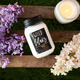Close-up of scent notes label on Milkhouse Wild Lilacs candle highlighting florals and greens.