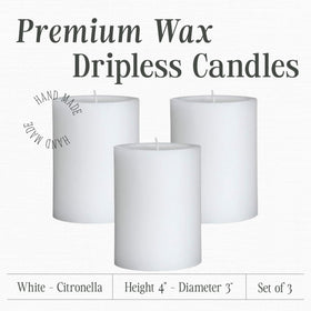Mister Candle white pillar candles on outdoor table for ambient lighting.