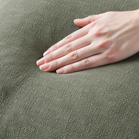 MIULEE olive fringe pillow cover on a sofa, adding boho charm