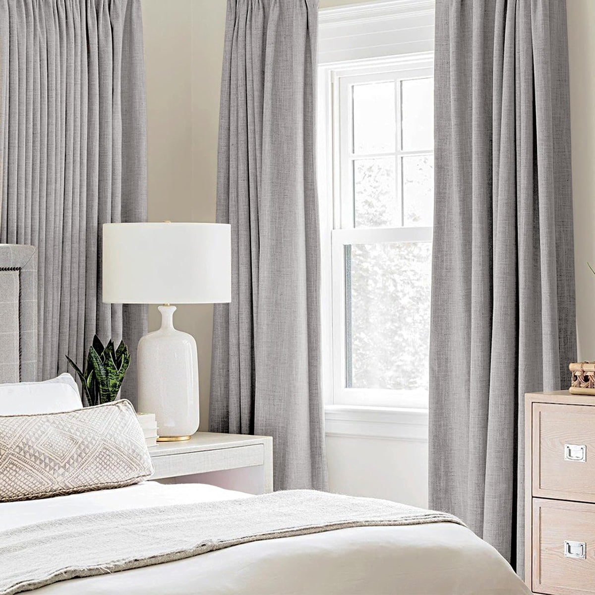 MIULEE light gray blackout curtains with eight grommets for easy hanging.