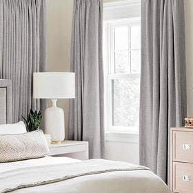 MIULEE light gray blackout curtains with eight grommets for easy hanging.