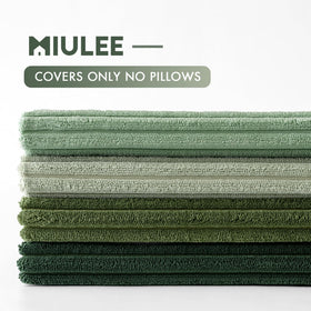 MIULEE sage green pillow cover on bed with coordinated textiles.