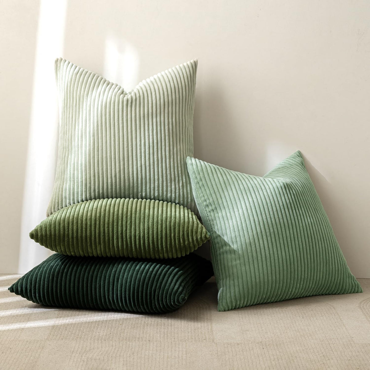 MIULEE sage green pillow cover set of four displayed on sofa.
