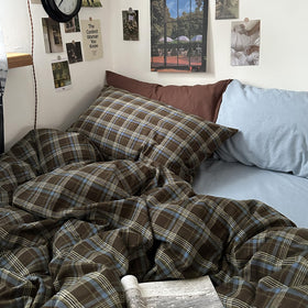 Mixinni buffalo plaid pattern close-up in neutral brown and blue tones.