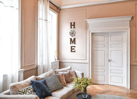Mkono Farmhouse wall decor features E letter to enhance room warmth.