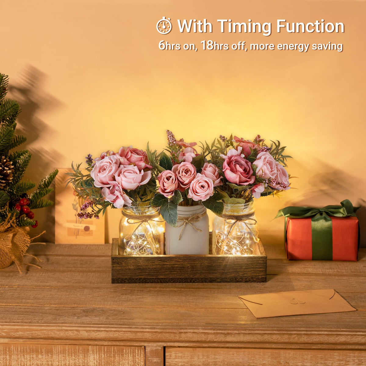 Mkono three jars with artificial flowers illuminated by warm string lights