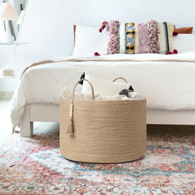 Mkono multiuse storage basket by the front door for quick organization of toys and accessories.