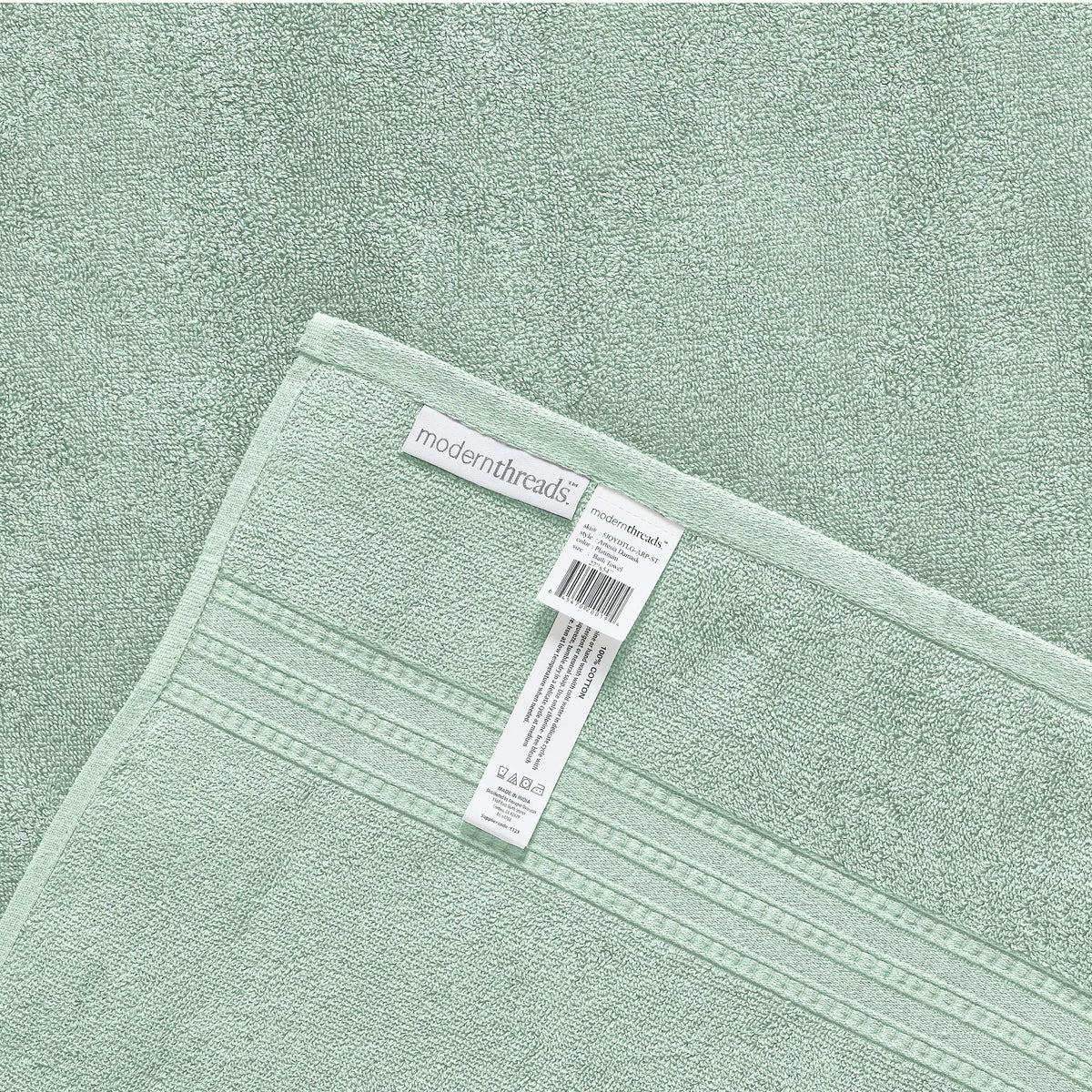 Modern Threads Artesia Damask Sage towel set on a bathroom display.