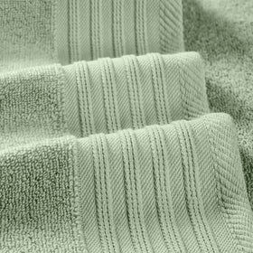 Close view of geometric olive pattern on Modern Threads towel detail.