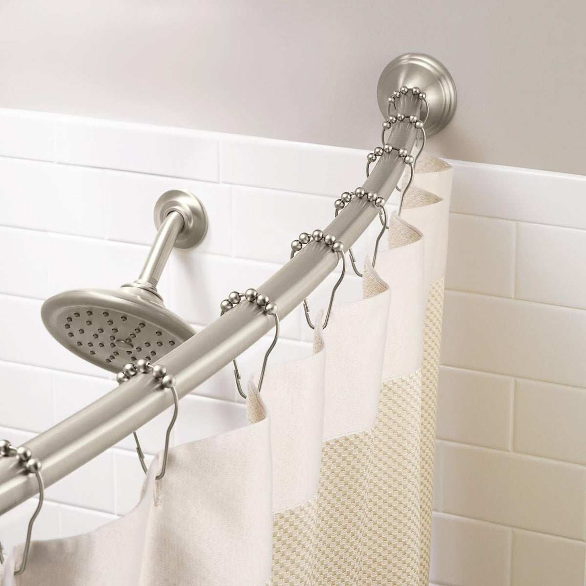Decorative covers hide hardware on Moen curved rod