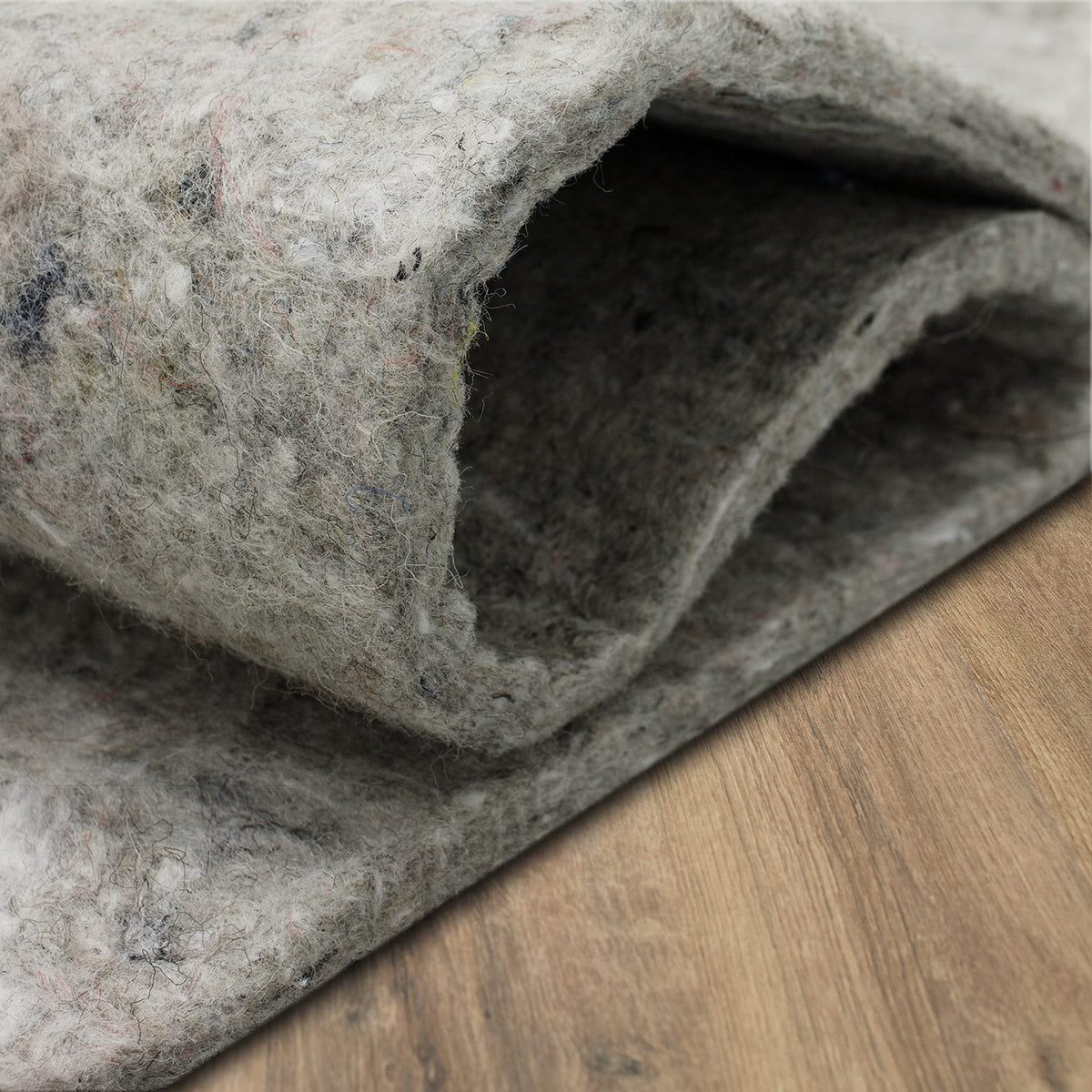 Mohawk Home felt rug pad protects floors under heavy furniture cushions.
