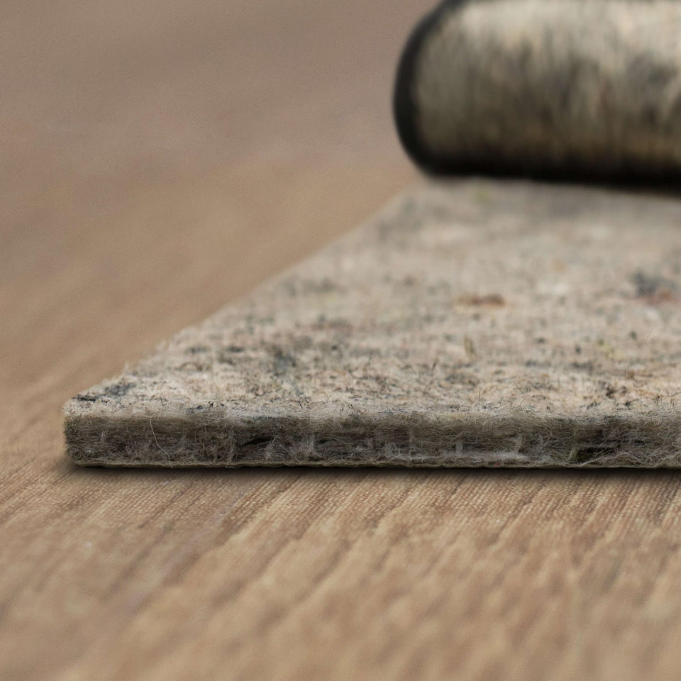 Mohawk Home non-slip rug pad on hardwood floor showing dual surface grip for stability