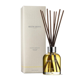 Molton Brown Orange & Bergamot Aroma Reeds bottle enhances entryway ambience with citrus freshness.