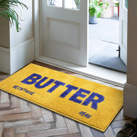 Momlli Butter Rug in bright yellow plush enhances kitchens with cozy footing.