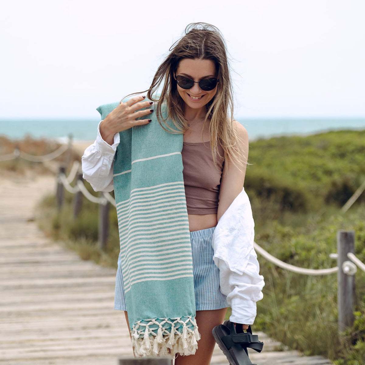 MOMOMUS beach blanket sea green yoga setup for stretches.