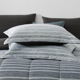 Monbix Queen bedding in a bag displays complete seven-piece set