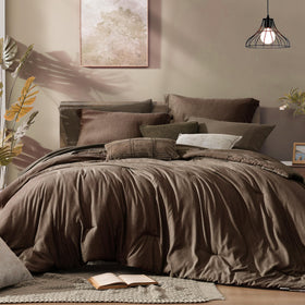 Monbix queen comforter close-up shows plush fabric for lasting softness