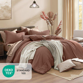 Sheets and shams laid out with the Monbix Queen Comforter Set for size and fit.
