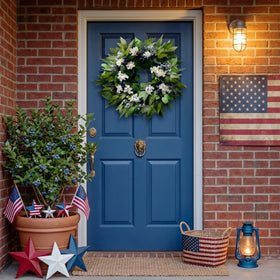 Montekin blueberry wreath brightens interior walls with white flowers.