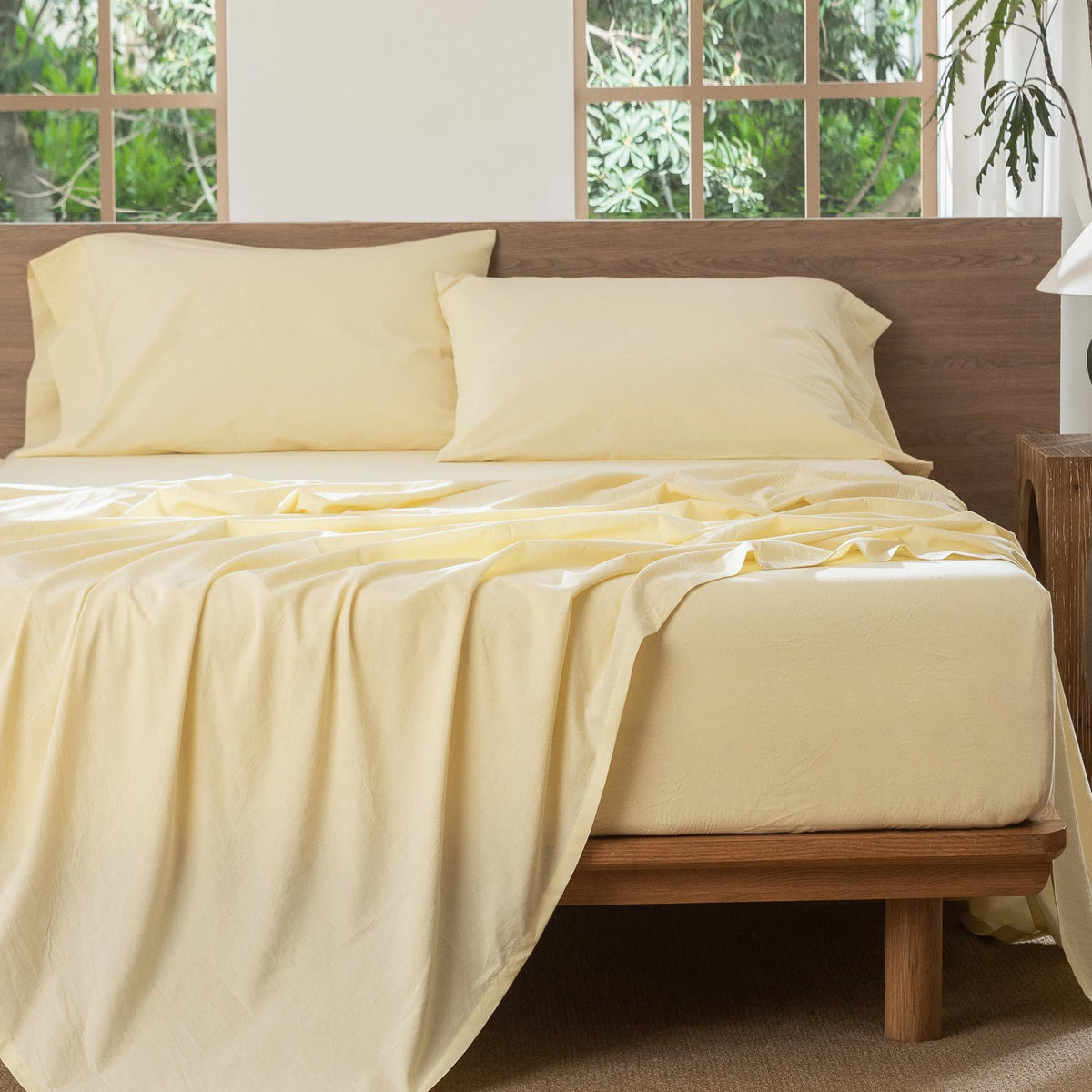 Butter yellow MooMee bedding styled in a cozy bedroom scene.
