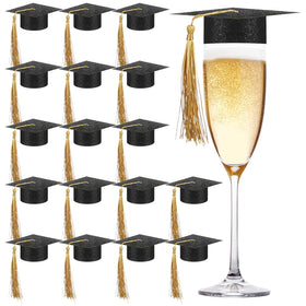 MotiMind mini graduation cap toppers on champagne flutes add festive flair.
