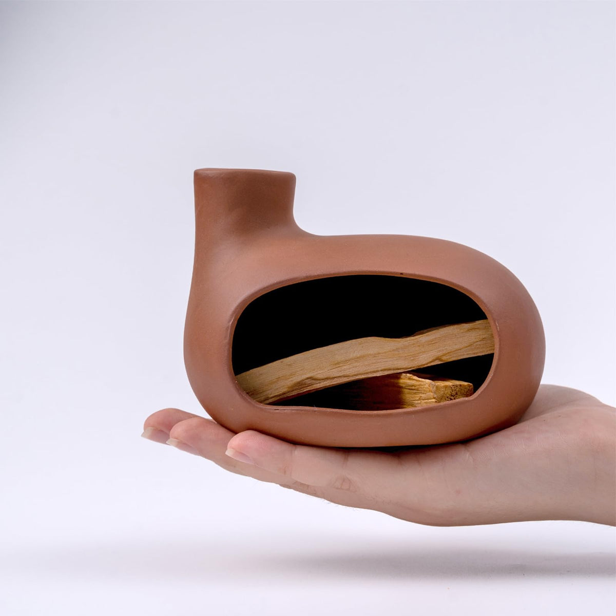 MOUGIGI Palo Santo Holder on its stand highlights modern design for calm spaces.