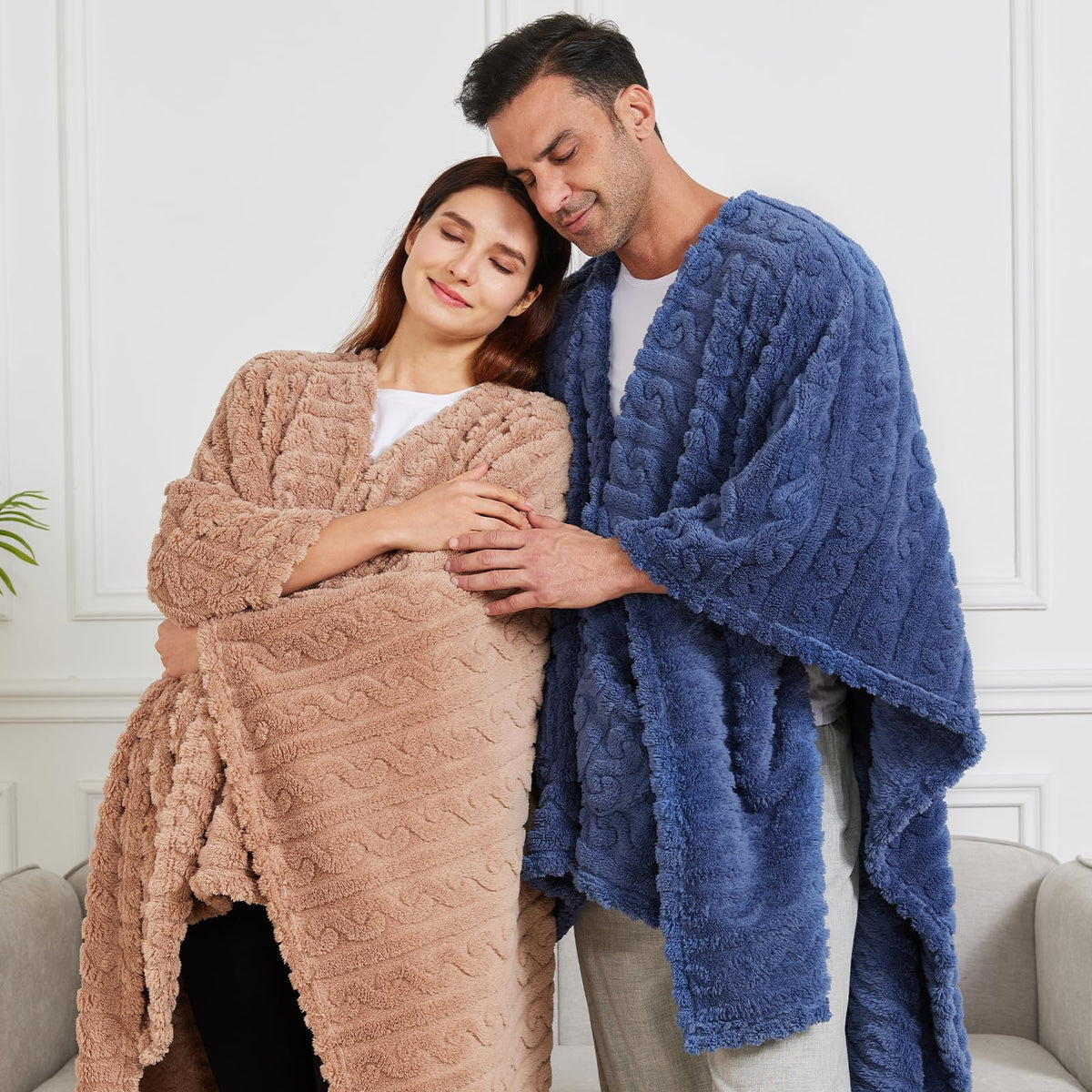 Mowkim dusty blue wearable blanket draped on a couch for comfort.