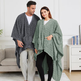 Mowkim sage wearable blanket shown on couch for relaxed comfort.