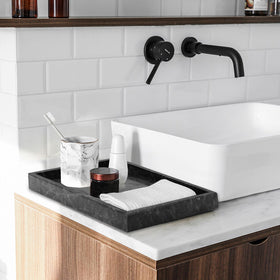 MULWR marble tray organizes jewelry on the vanity for clutter-free display.