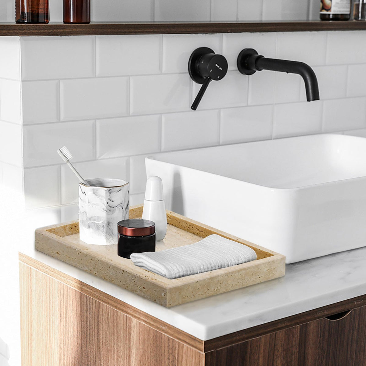 MULWR Travertine Tray resting near towels and jewelry by the sink for quick access.