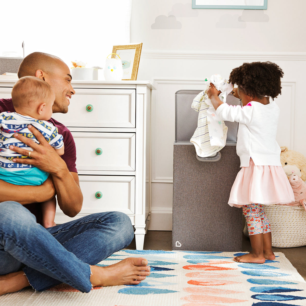 Munchkin collapsible design highlights compact storage in nursery or closet.
