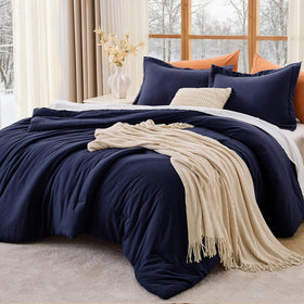 MUXHOMO Queen Comforter Set on a neatly made bed in navy for all-season comfort.