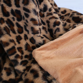 MYRU leopard blanket draped over bed for full lounging coverage.