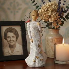 NAN ZAI NAN FANG Serenity Prayer angel in cream dress inspires quiet reflection