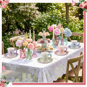 NatNarr garden party dining setup with cups and saucers for hosting.