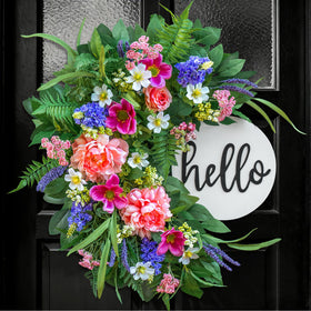 Naturawre 24-inch spring wreath on front door with Hello sign boosts curb appeal.