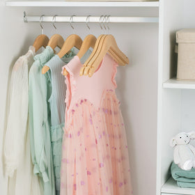 Nature Smile durable hangers support growing children's outerwear through seasons.