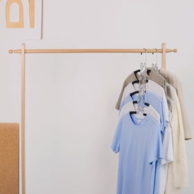 Nature Smile four-pack black hangers ideal for streamlined closet organization.